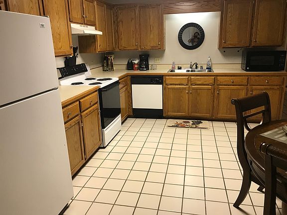 Huge fully equipped kitchen with refrigerator, stove, coffee maker, pots and pans, dishes, dishwasher, microwave, blender