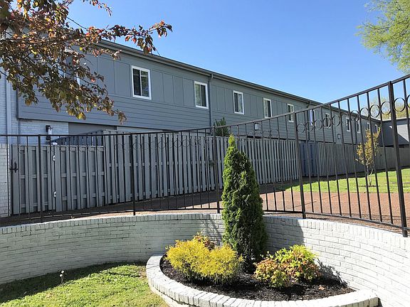 All windows and fenced patio looking at beautiful courtyard