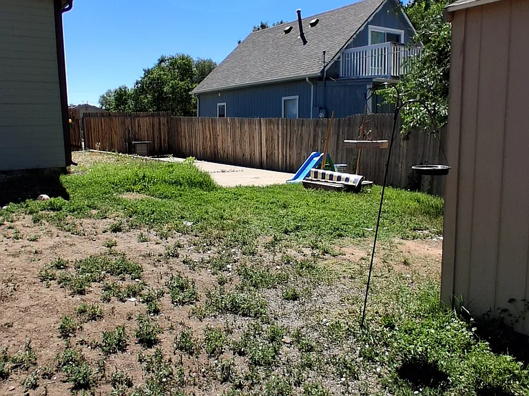 Second driveway to pull an oversized vehicle into the fenced backyard