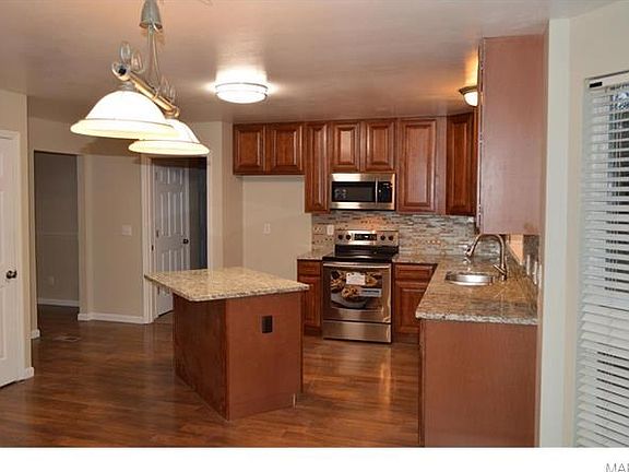 Kitchen with new cabinets, granite tops, faucet, flooring, lighting - breakfast room with bay/door to outside - great room to far right