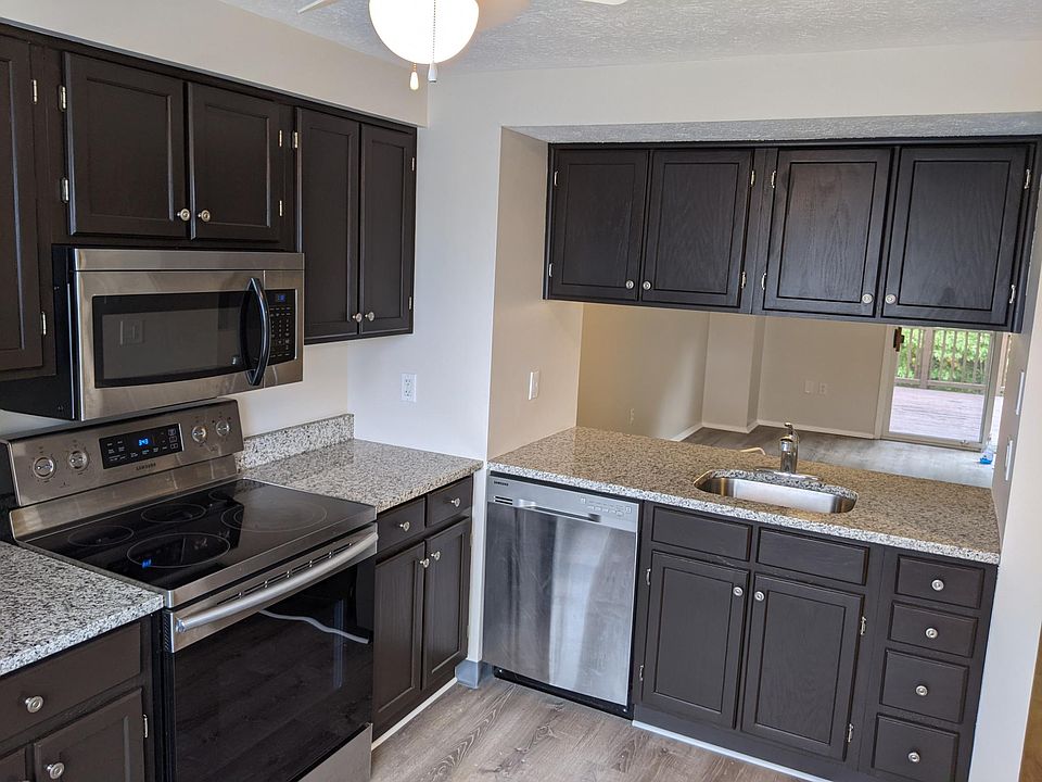 Kitchen with new vinyl plank floor, granite countertops and stainless appliances!