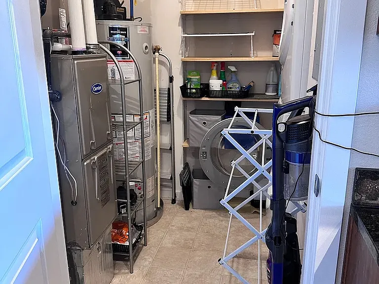 Furnace, water heater, washer/dryer & storage.
