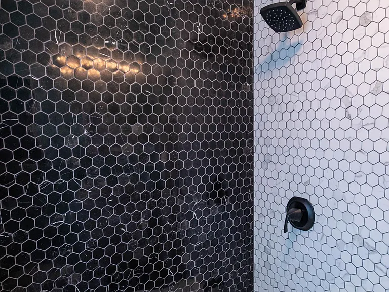 close up black and white tiled tub and shower