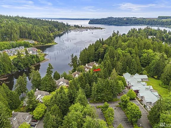 This aerial photo shows the Bay Club, with all it's amenities, on the right, with the bay, marina and shipping lanes beyond! The home is in the center of the photo (next to the red arrow), just steps away from everything the area has to offer!