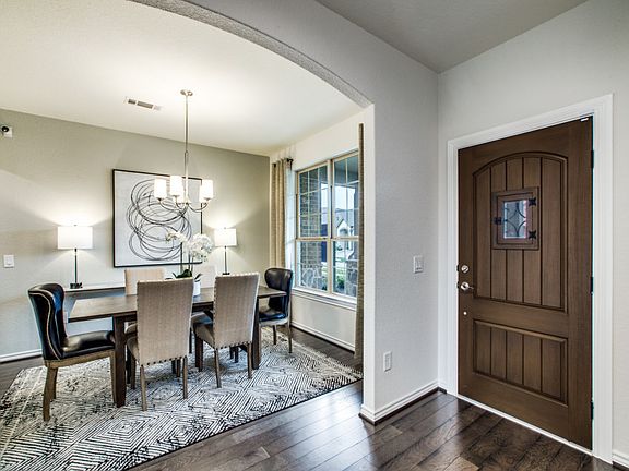 Welcoming entryway into home with dining room