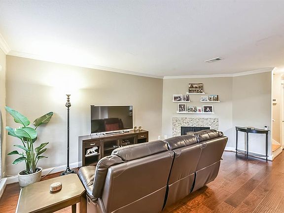 The living area has crown molding and engineered wood floors.