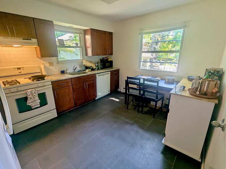 Eat in kitchen with Cherry Cabinets, granite countertop.