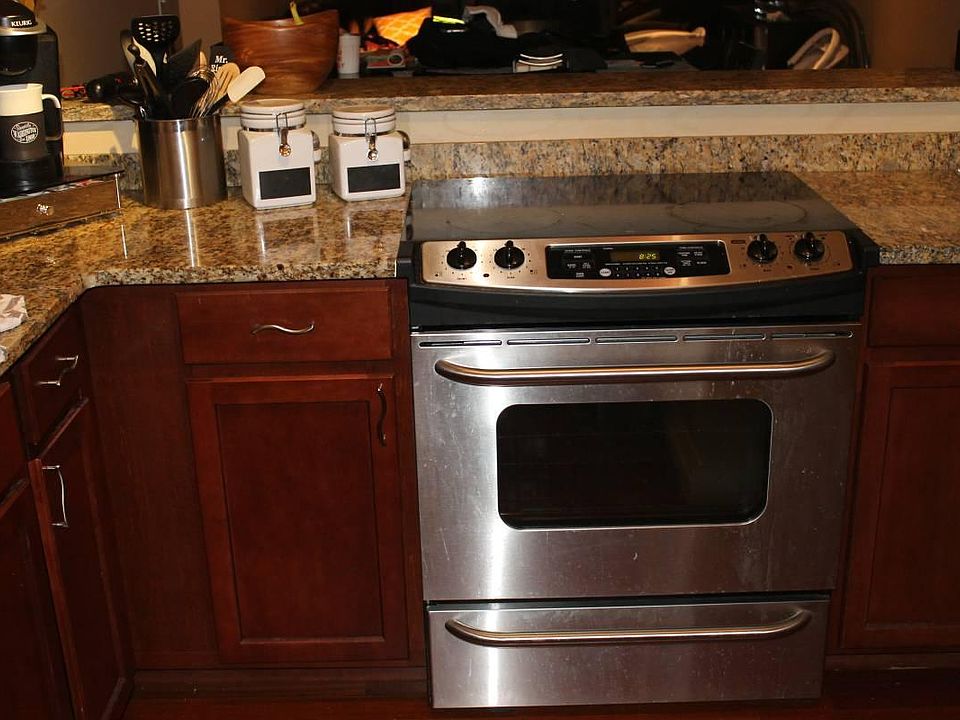 updated kitchen with granite and stainless steel appliances