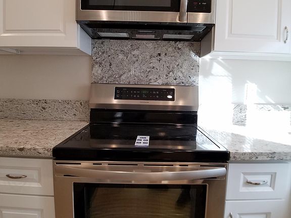 New Frigidaire induction stove that boils hot water faster than a gas stove without toxic fumes. Frigidaire microwave with exhaust vent through the roof.