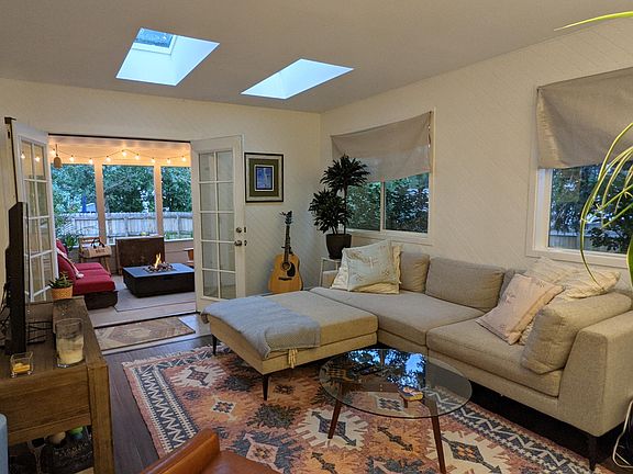 Living room opens up to covered back patio with firepit.