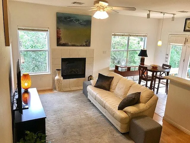Beautiful wood floors lead the eye to sweeping views of nature, framed by the living room windows and dining room windows and are highlighted by sunlight streaming through the glass atrium doors