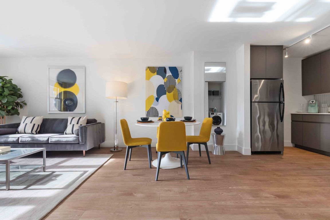 Open concept living area with wood-look plank flooring