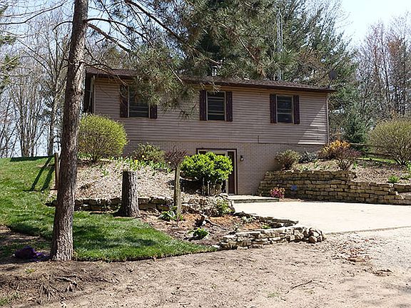 15 acres of woods is VERY PRIVATE and the buildings sit way back off the road.  The house has 3 bedrooms and a den,1 1/2 bath and a 24' x 40' garage/barn building . The 2 story open living room has the  open stairway to the upstairs family room at the top of the stairs.The Beautiful kitchen has a new Concrete 8000 Max countertop.The walk-in pantry is at the end of the kitchen.The den on the main level ,can be the 4th bedroom or office,if needed.Many updates,roof was new in 2009,Dishwasher,disposal were new in 2014. In 2004 the 5" well was new.