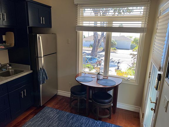 Front room - kitchen and living area. Expand-collapse table with two stools.