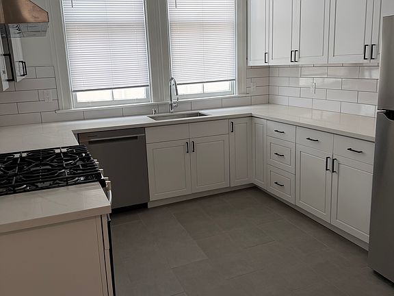 New kitchen with gas stove, dishwasher, and full size refrigerator.