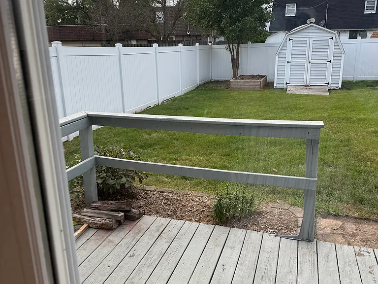 Deck with fenced yard and shed.
