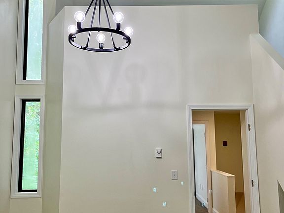 Bright and Sunny LARGE Main Bedroom with Vaulted Ceilings, Chandelier, and Staircase to Loft.