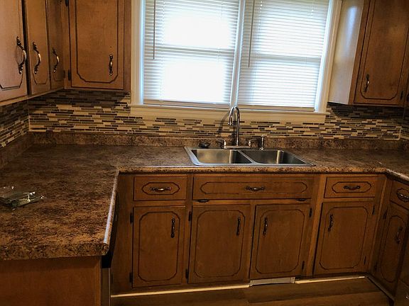 KITCHEN HAS BEAUTIFUL SINK, COUNTERTOP AND BACKSPLASH