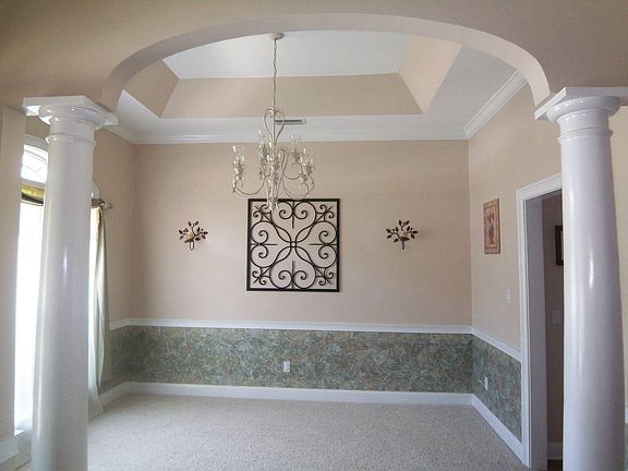 dining room has columns and trey ceiling