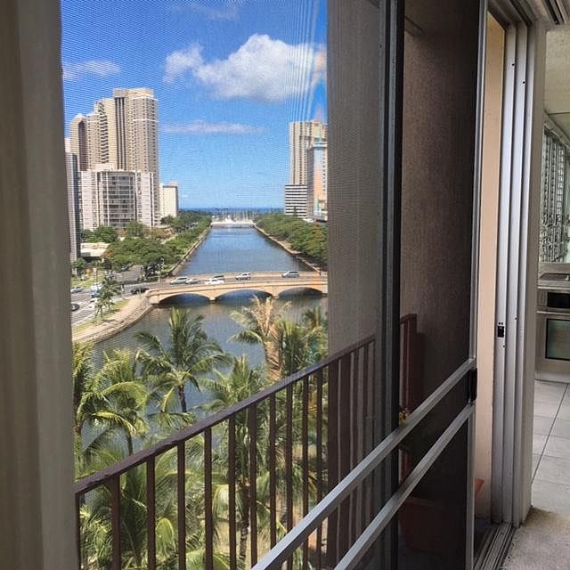 Your view if the Ala Wai looking towards the Kalakaua Bridge to the Pacific Ocean surrounded by coconut trees and sunsets enjoyed by all who live here