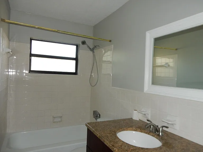 granite counter top in bathroom and bath tub.