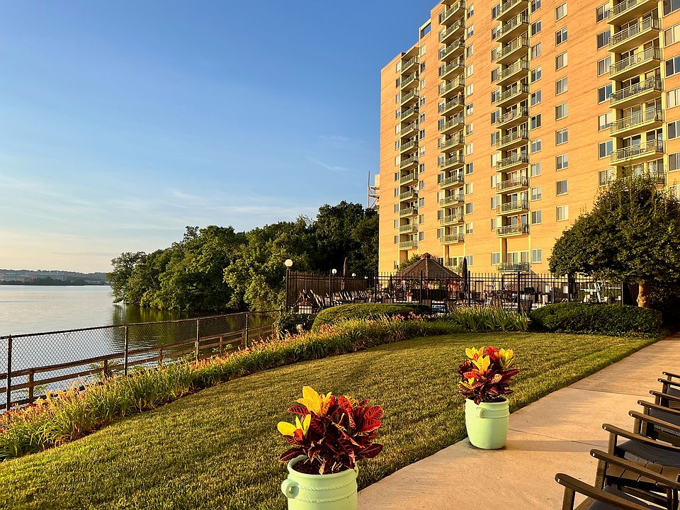 view of back of Marina Towers ; pool ; tiki bar with grills; bike trail .