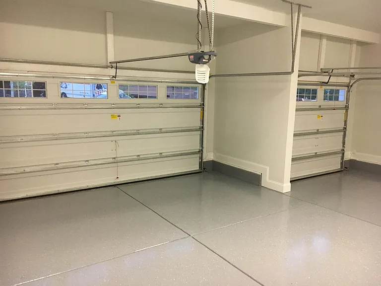 3-car garage with finished walls and epoxy floors