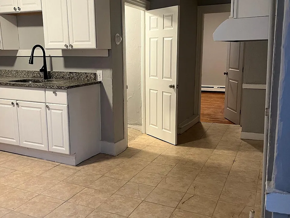 View of bedroom and bathroom door from the kitchen