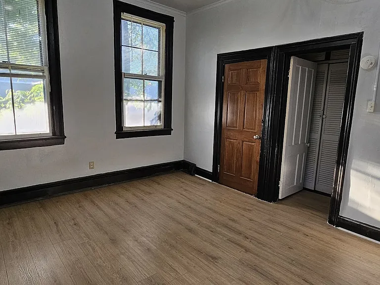 Living Room facing street and front door and bedroom door