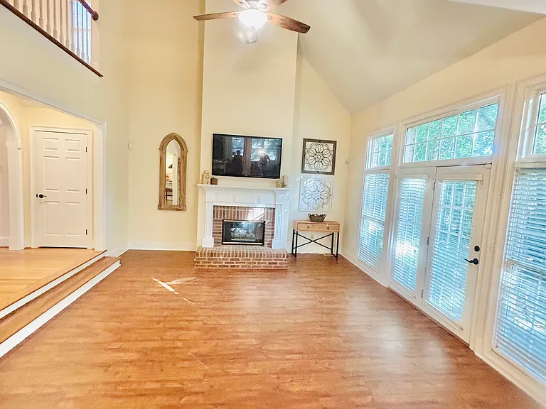 Sunken Living room features vaulted ceilings, gas fireplace and loads of natural light!