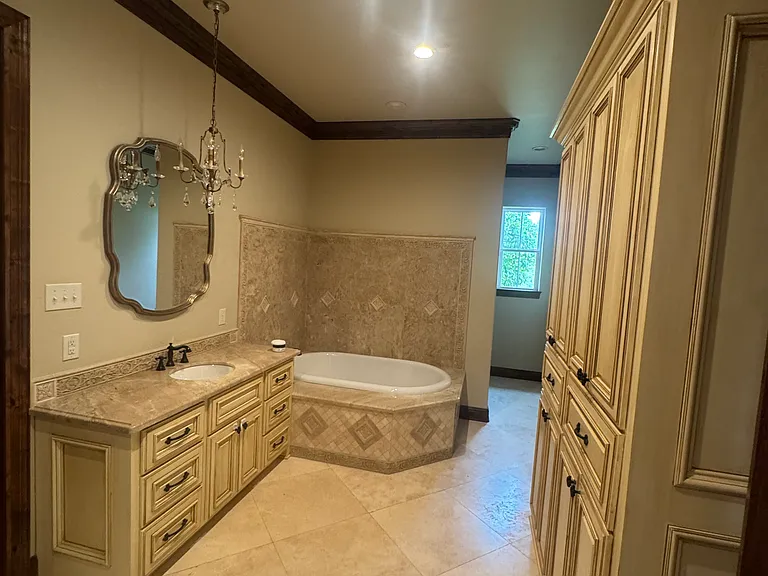 Master bath with his and her vanity and garden tub