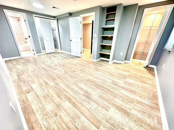 This suite has two closets, plus built-in live-edge shelves!