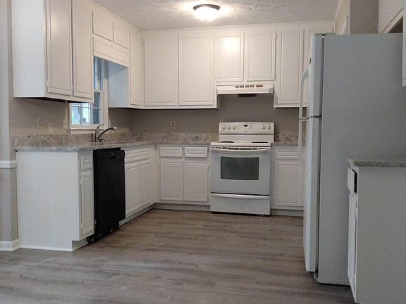 Kitchen with new LVP flooring, new granite countertops, new lighting, newly painted cabinets, new stainless sink and faucet. Stove will be replaced