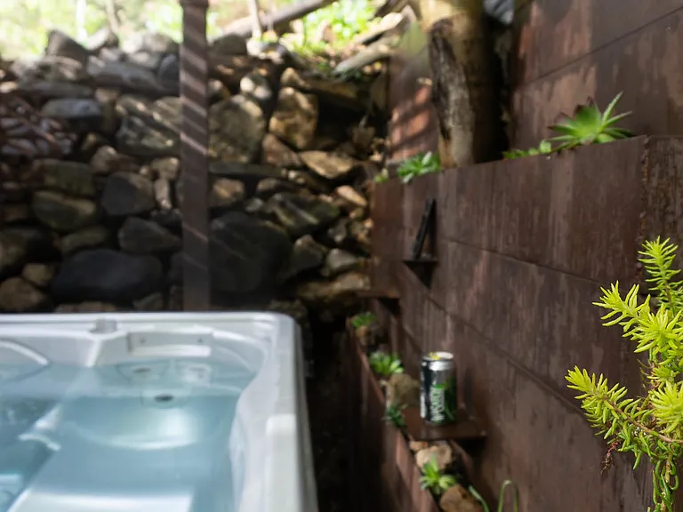 Spa grotto in the summer. With drink shelves.