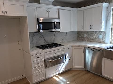 New kitchen floors,room for a large refrigerator, new vented over range microwave, warming drawer and dishwasher.