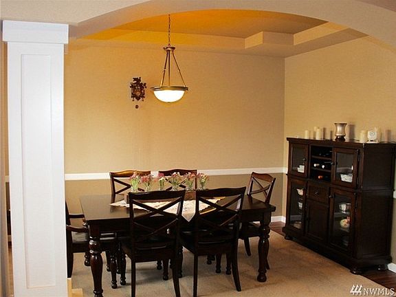 Large dining room with coiffured ceilings and chair rail.  Plenty of room for everyone to gather.