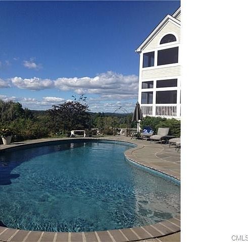 Kidney shaped Gunite pool with patio and view to northwest.