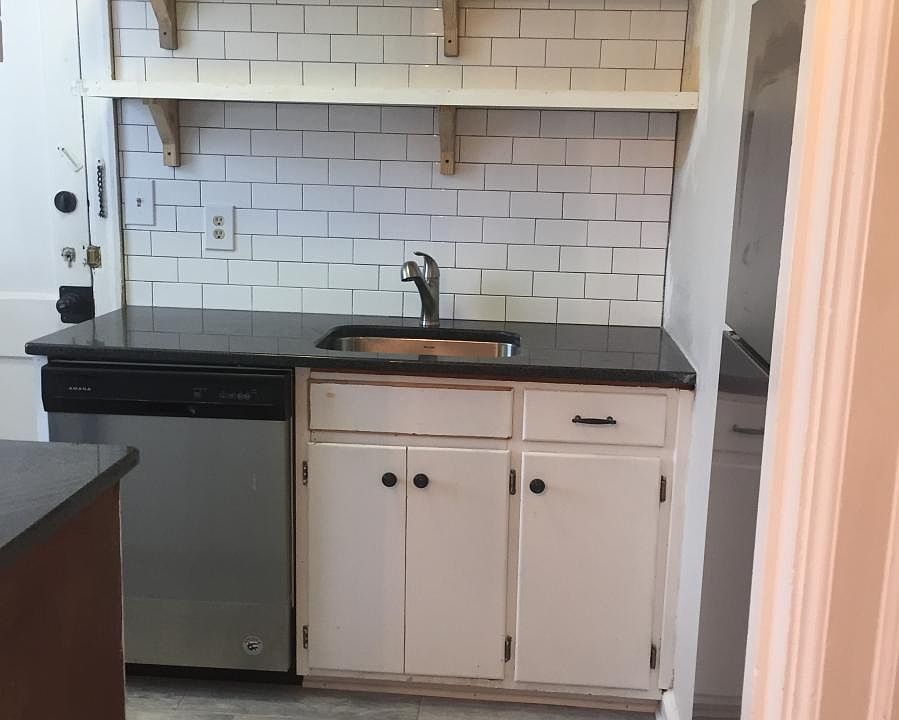 Open shelving with new Dishwasher and subway backsplash
