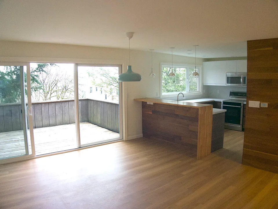 Sliding glass doors in the great room open onto a private deck measuring 11' x 16'. The deck has a gas hookup for a grill and a hose for container gardening. Perch at the bar for coffee, a meal, or a snack.