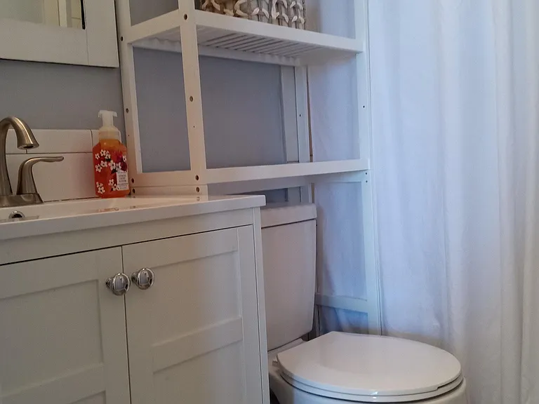 The bathroom has a abundant shelves for all your toilitries.