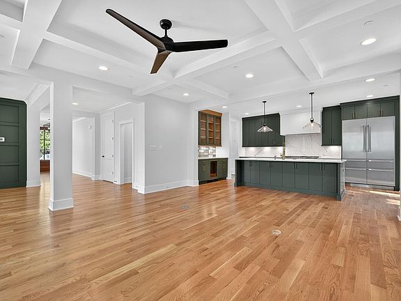 Island anchors the open plan - cabinetry does the rest.