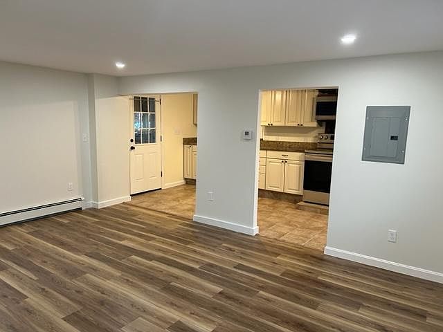 Living room looking into kitchen. Back door leads to covered porch