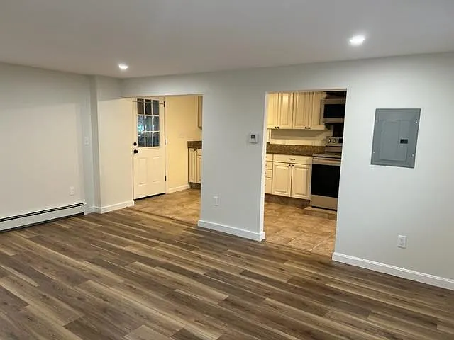 Living room looking into kitchen. Back door leads to covered porch