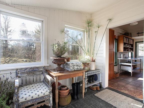Another view of the mudroom, kitchen visible through doorway