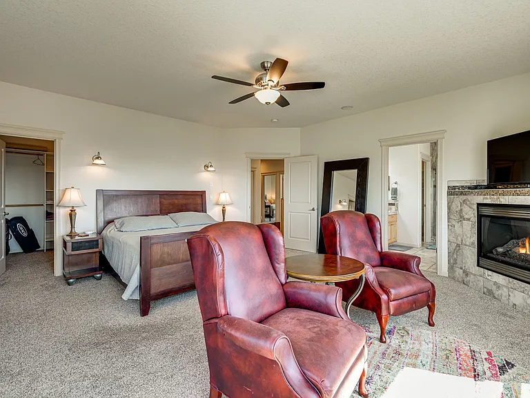 Lots of space in the large primary suite, featuring a walk-in closet, seating area, and dream worthy view
