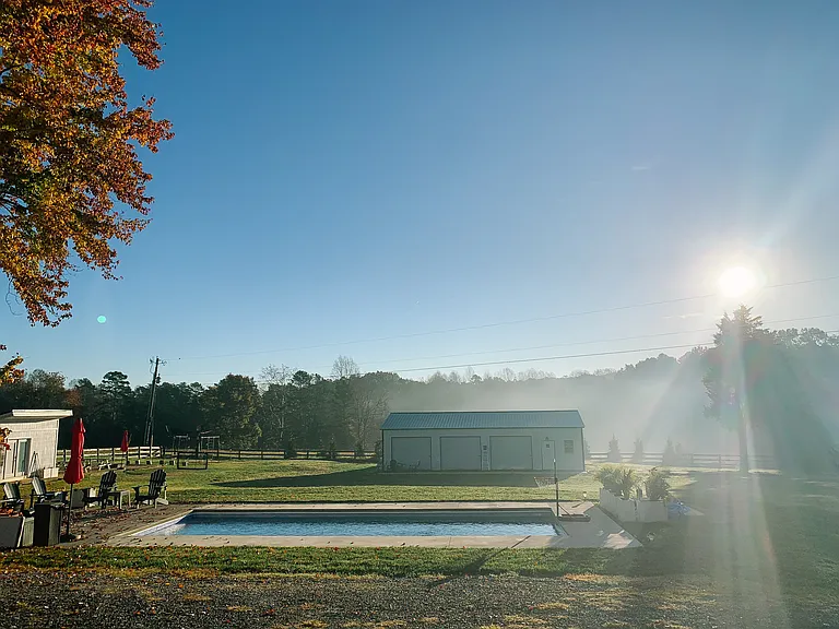 Backyard: in-ground pool, leveled sports field, mini office and large studio