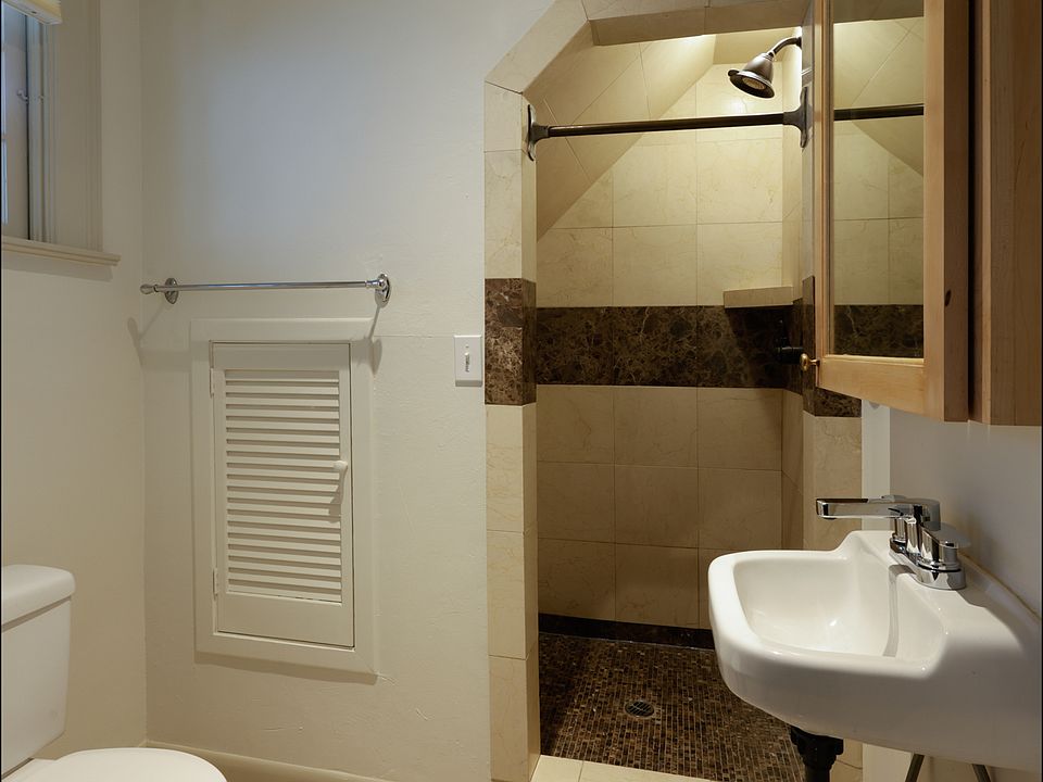 bathroom w/marble tiled shower stall