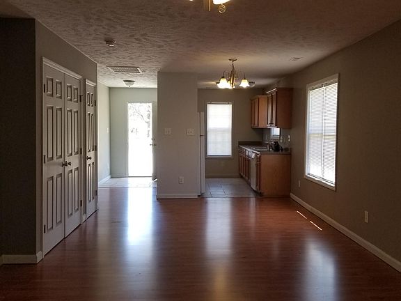 View from back of the apartment. Showing Living Area, Entry Way, Kitchen, Laundry Hookup and Coat Closet.
