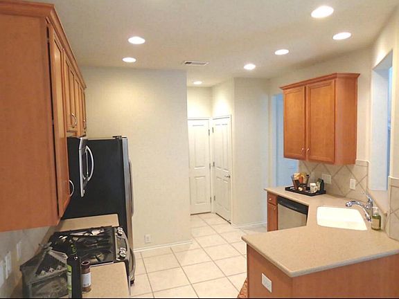 Sparkling kitchen with Stainless appliances and gas range.