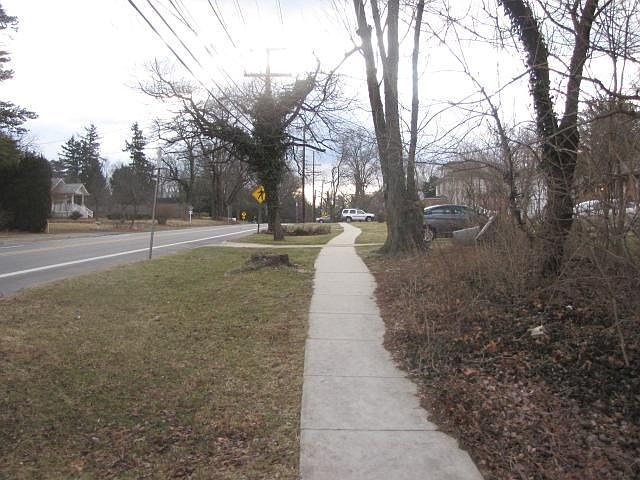 Sidewalk leads to library across the street from the white care ahead. Restaurants and within 2 blocks